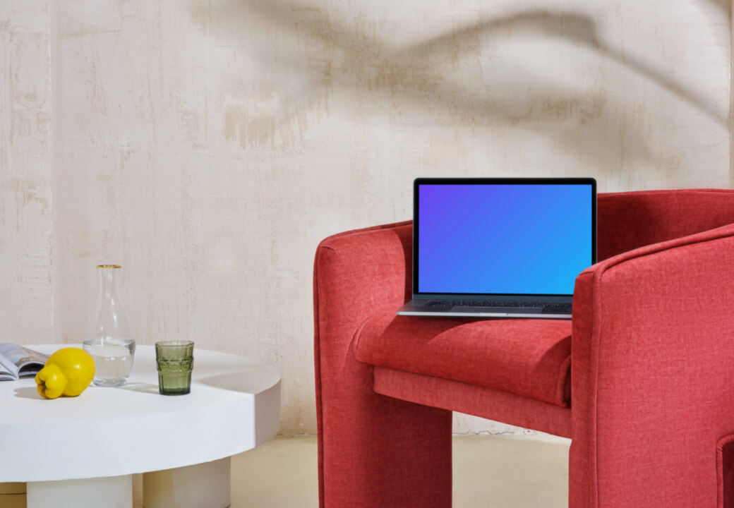 MacBook mockup on a red couch