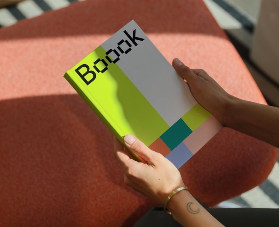 Hands holding book mockup