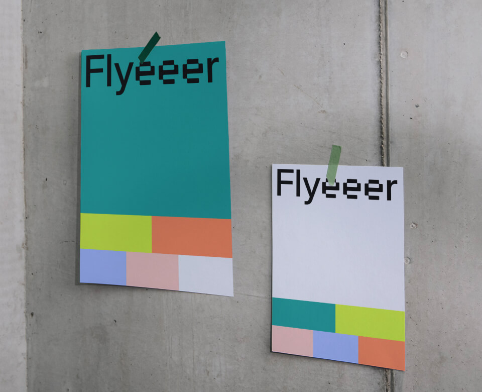 Two flyer mockups on the wall