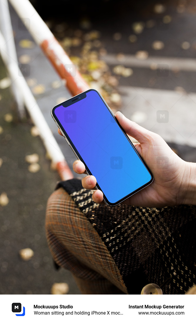 Download Woman sitting and holding iPhone X mockup - Mockuuups Studio