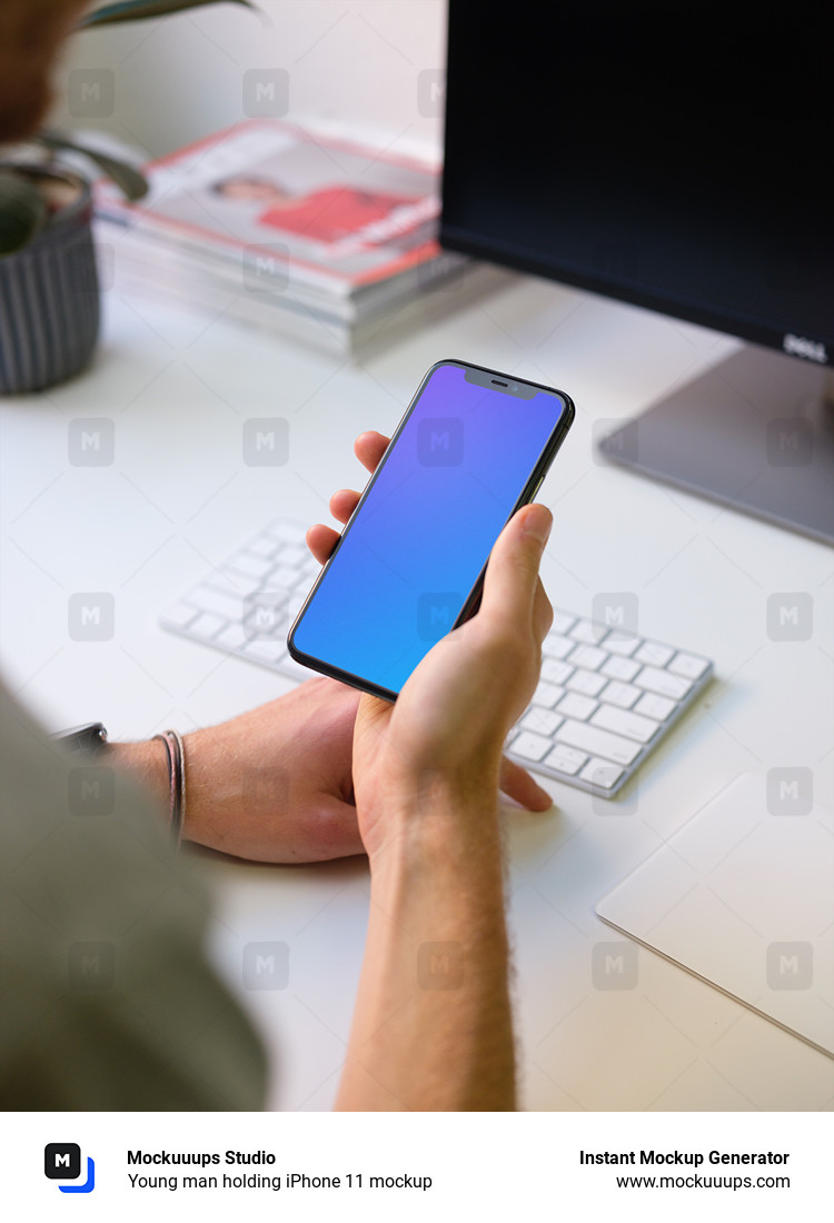 Download Young man holding iPhone 11 mockup - Mockuuups Studio