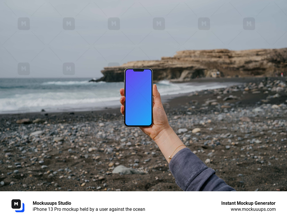 iPhone 13 Pro mockup held by a user against the ocean