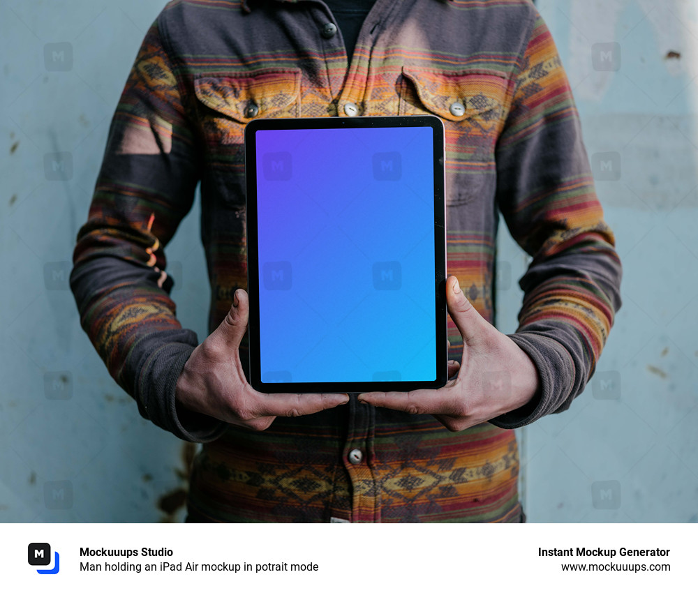 Man holding an iPad Air mockup in potrait mode