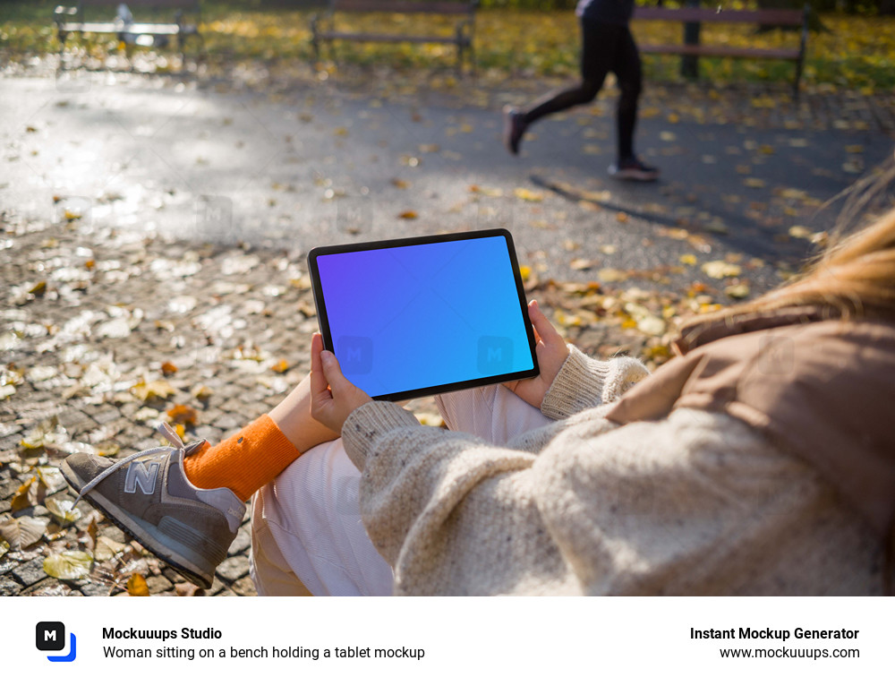 Woman sitting on a bench holding a tablet mockup