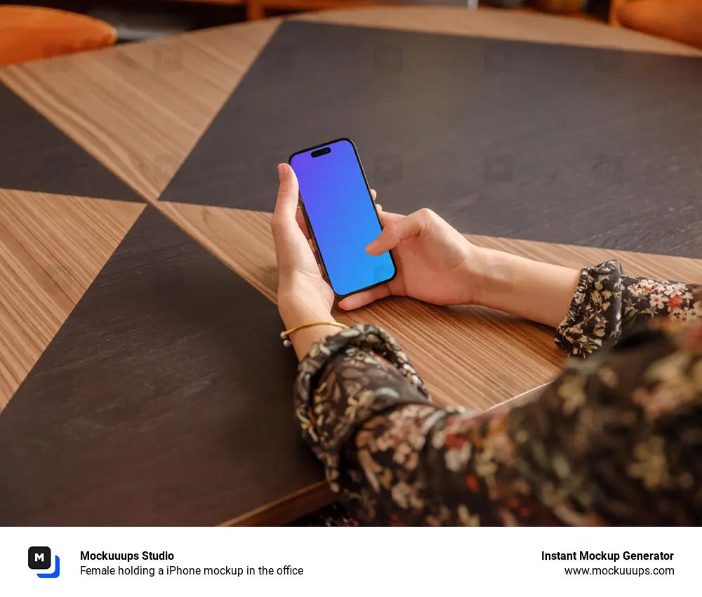 Female holding a iPhone mockup in the office