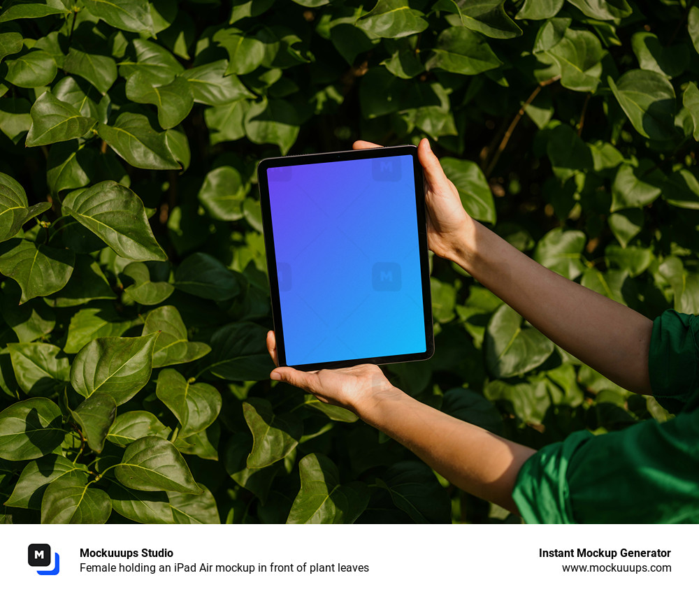 Female holding an iPad Air mockup in front of plant leaves