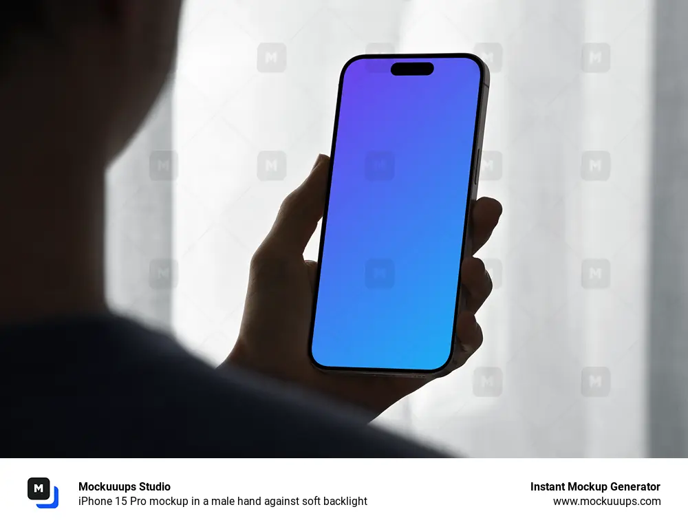 iPhone 15 Pro mockup in a male hand against soft backlight