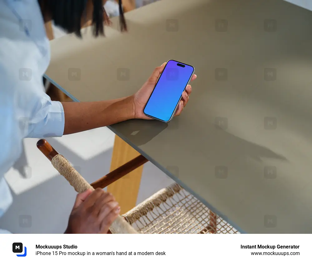 iPhone 15 Pro mockup in a woman's hand at a modern desk