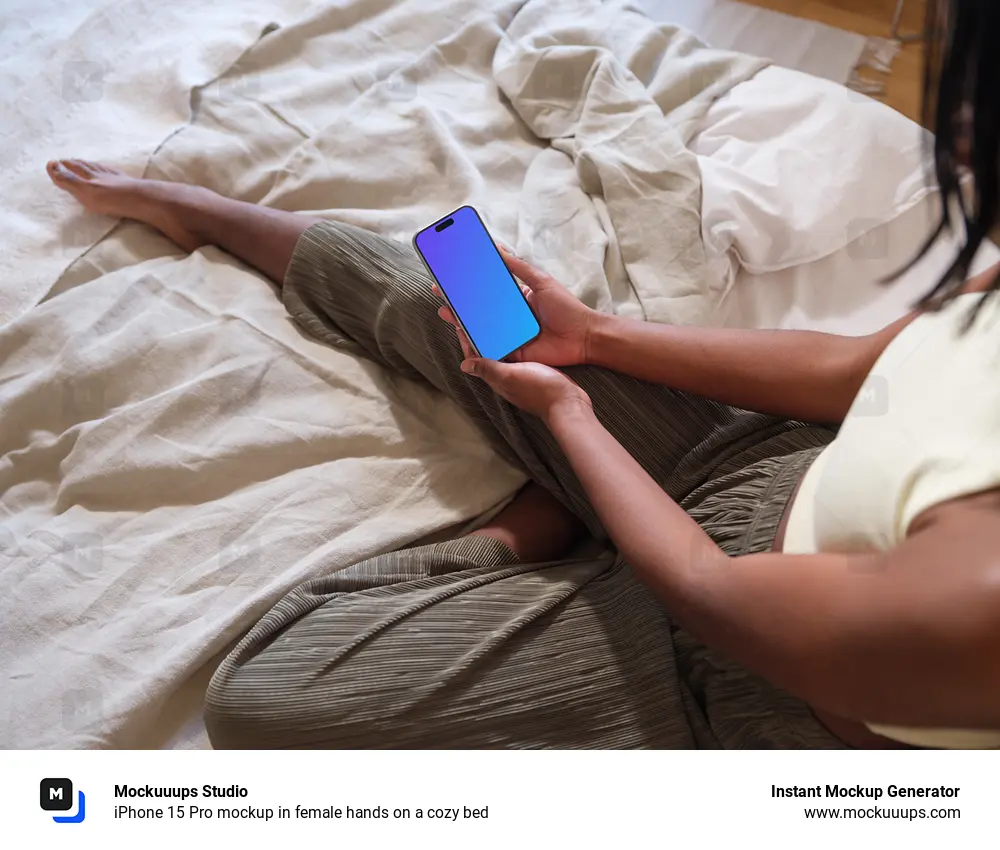 iPhone 15 Pro mockup in female hands on a cozy bed