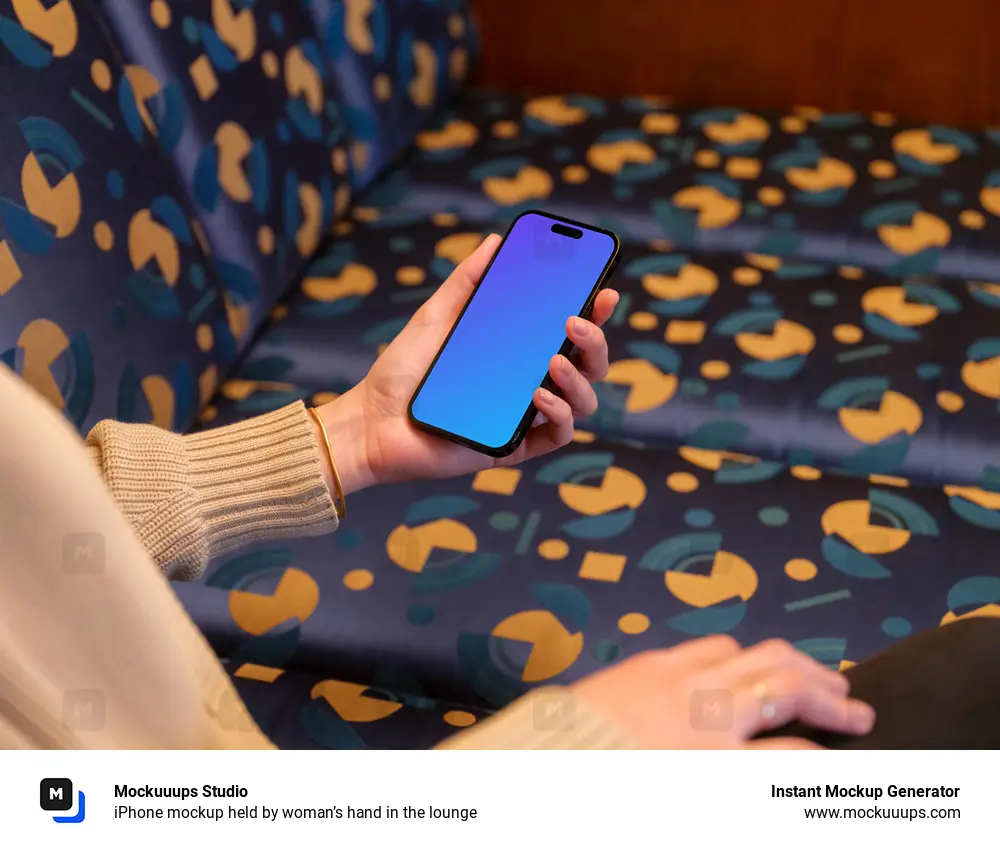 iPhone mockup held by woman’s hand in the lounge 