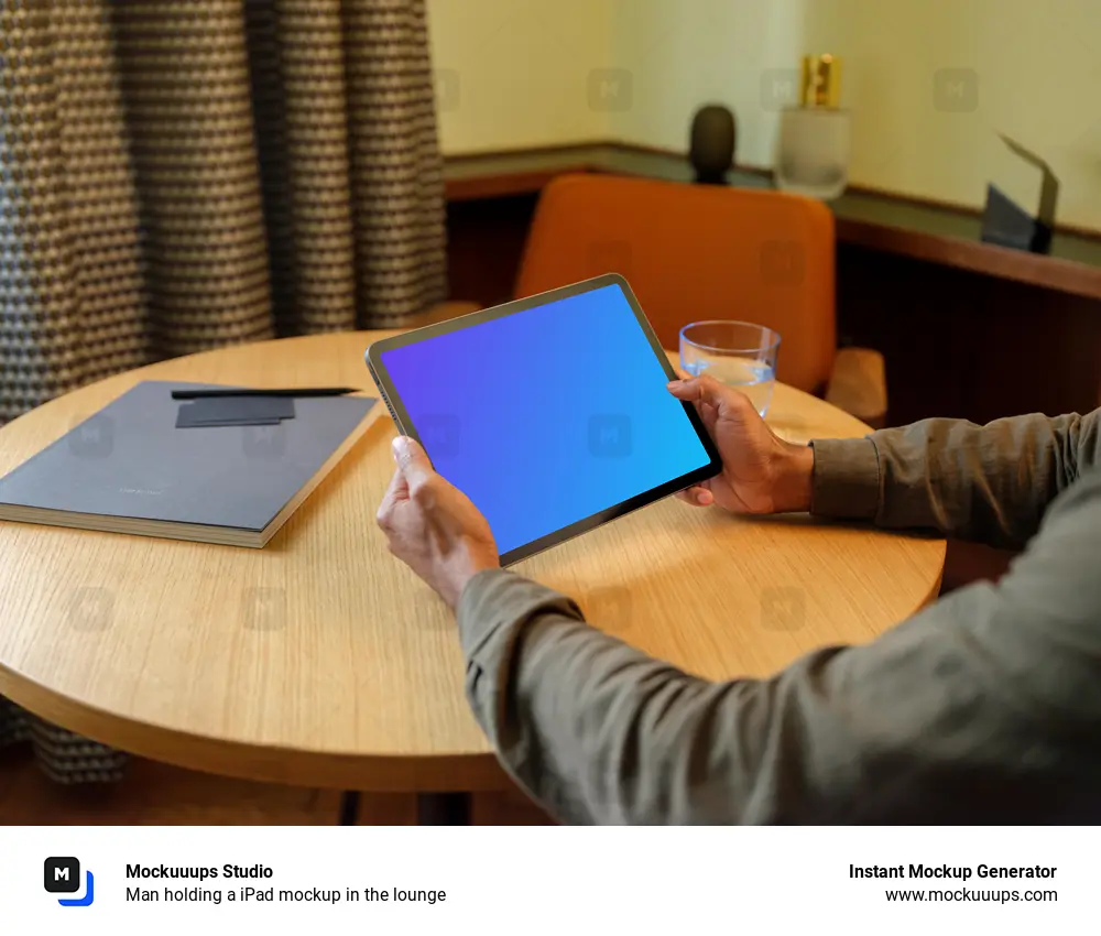 Man holding a iPad mockup in the lounge