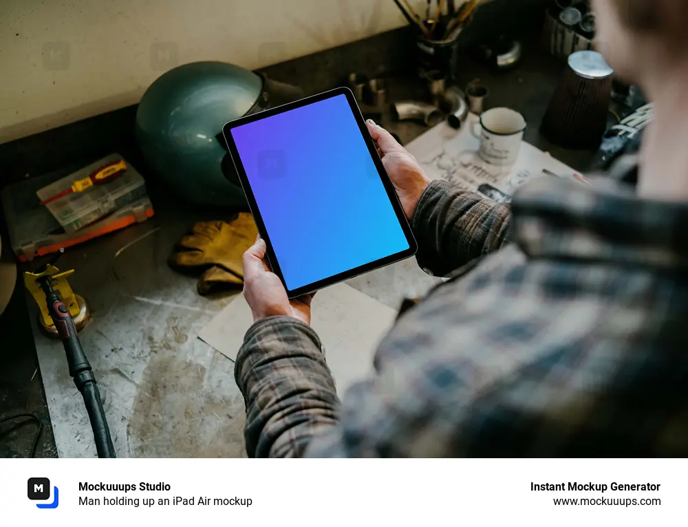 Man holding up an iPad Air mockup