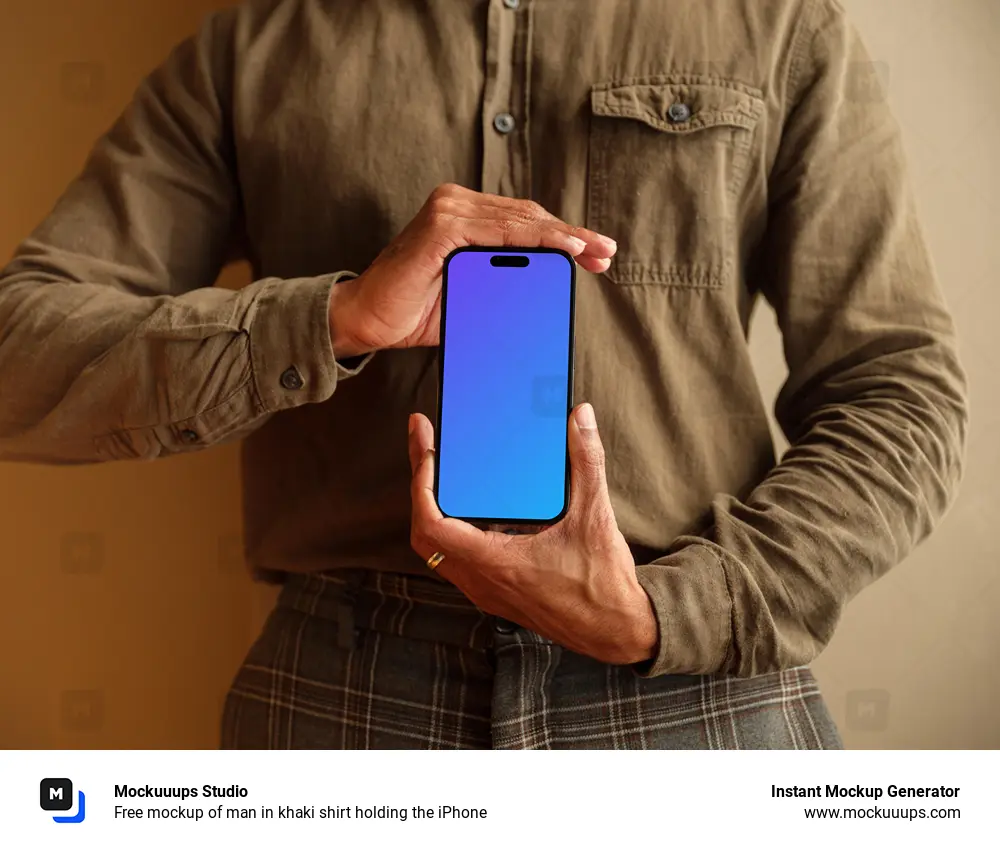 Free mockup of man in khaki shirt holding the iPhone