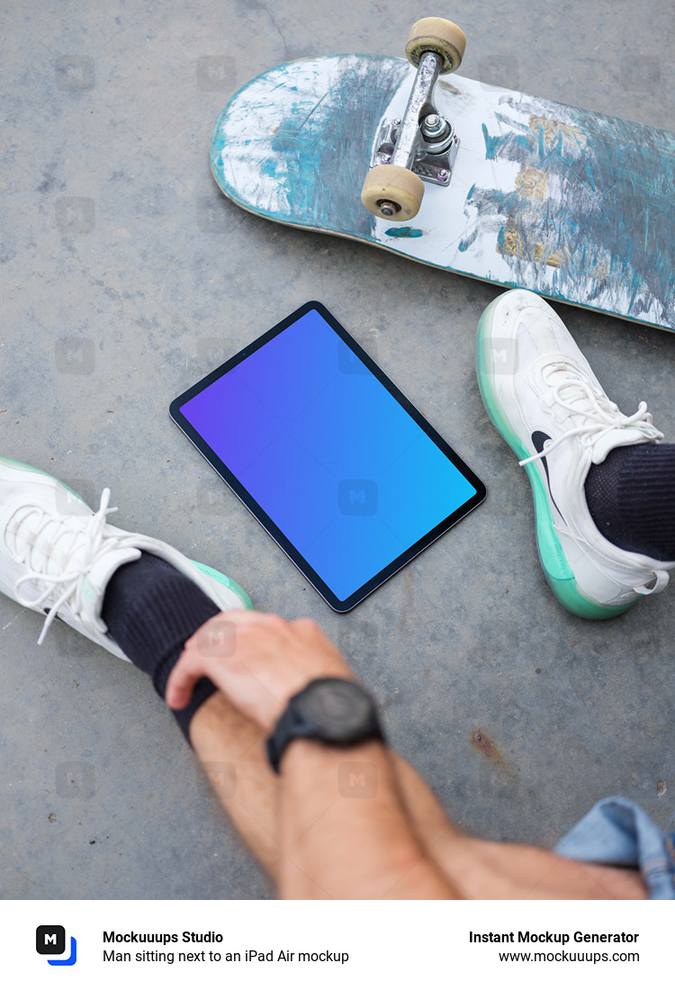 Man sitting next to an iPad Air mockup