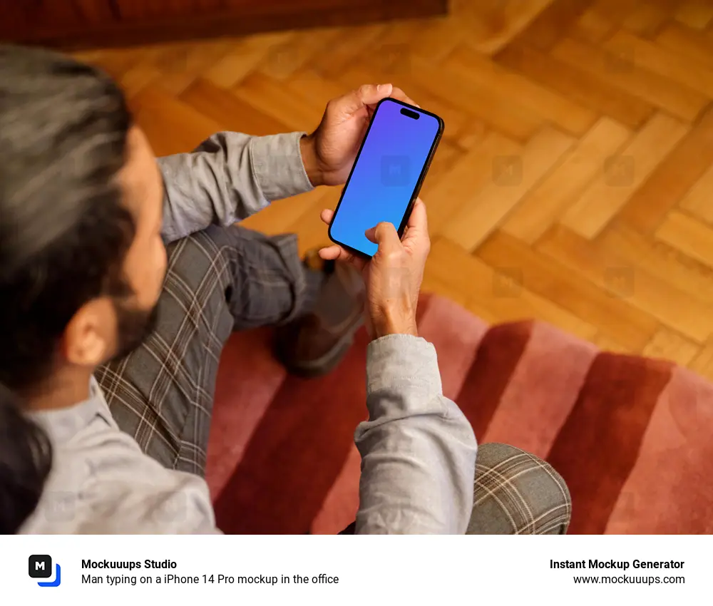 Man typing on a iPhone 14 Pro mockup in the office