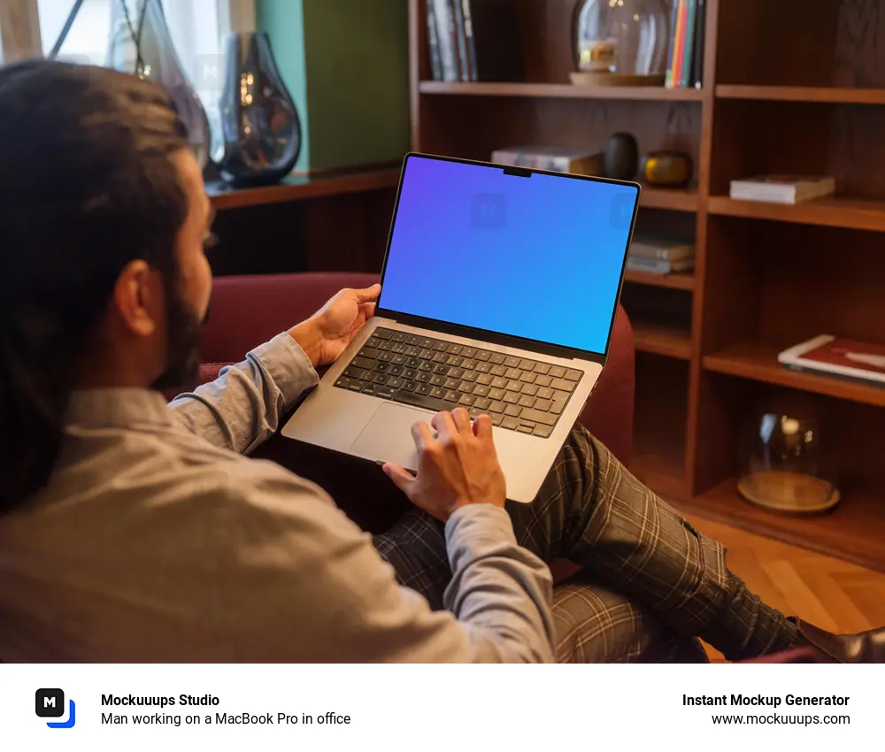 Man working on a MacBook Pro in office