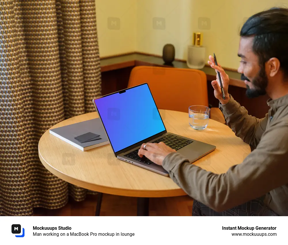 Man working on a MacBook Pro mockup in lounge 