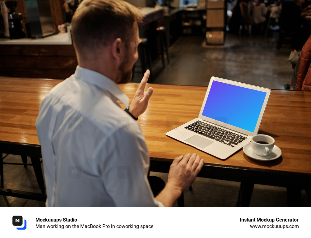 Man working on the MacBook Pro in coworking space