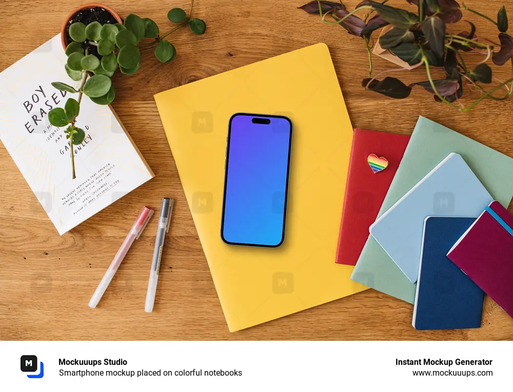 Smartphone mockup placed on colorful notebooks