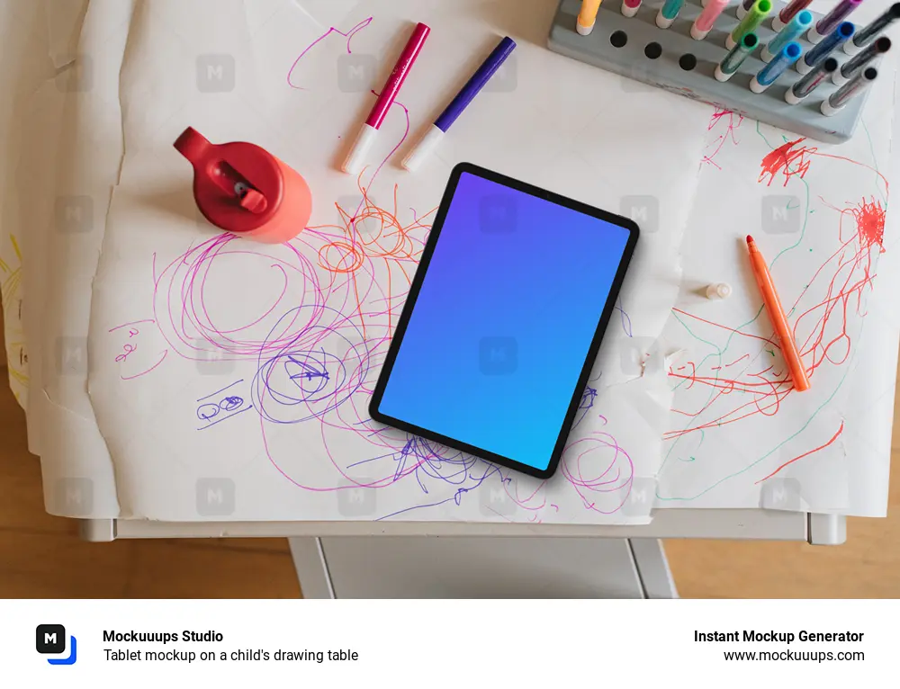 Tablet mockup on a child's drawing table