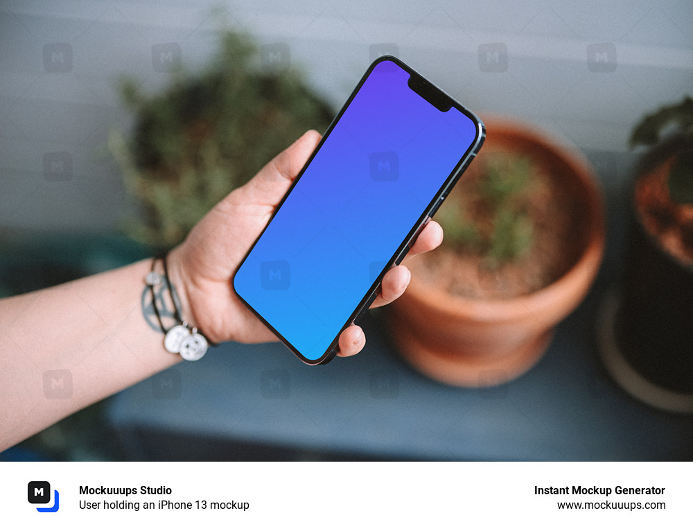 User holding an iPhone 13 mockup