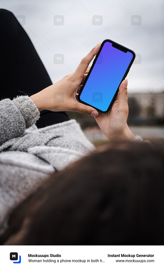 Woman holding a phone mockup in both hands