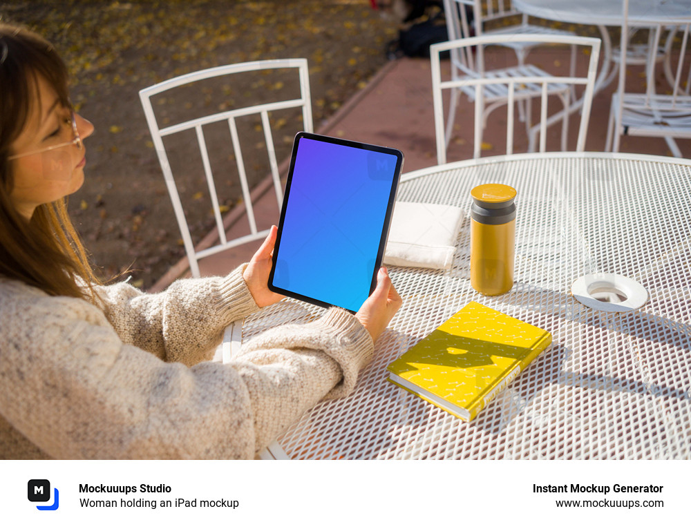 Woman holding an iPad mockup