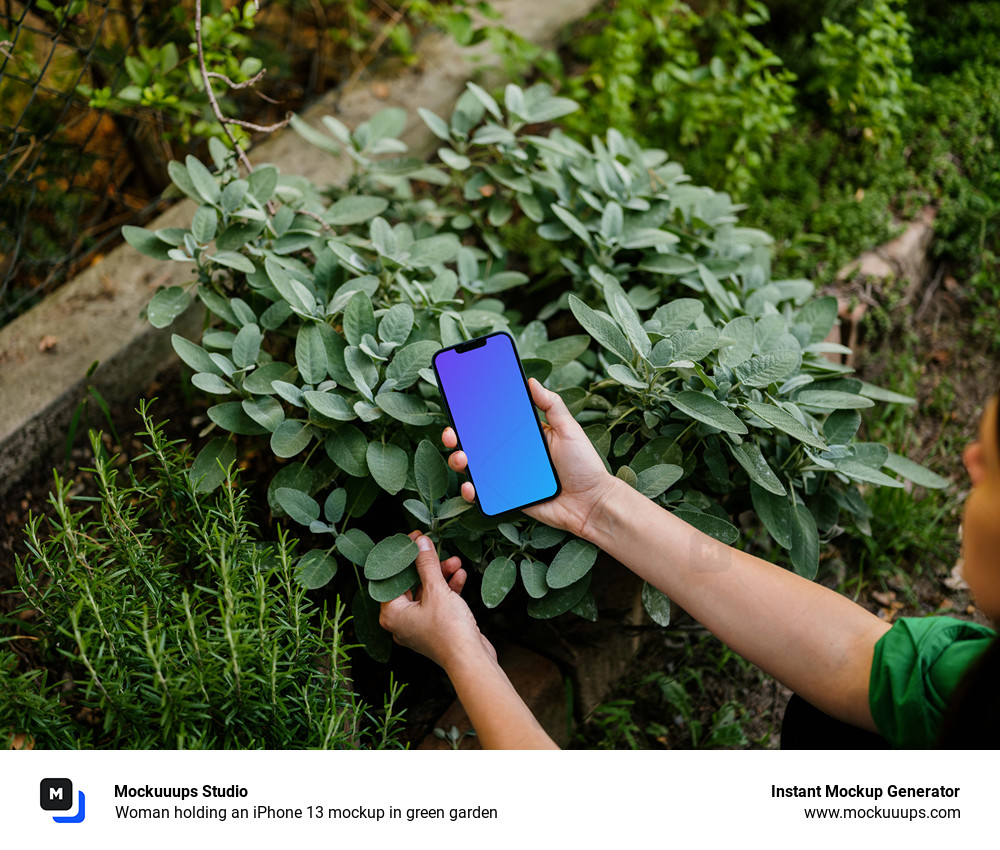 Woman holding an iPhone 13 mockup in green garden