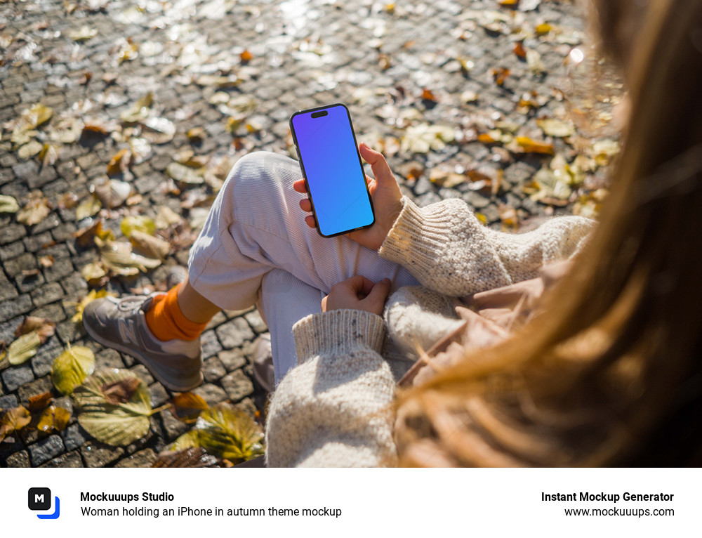 Woman holding an iPhone in autumn theme mockup