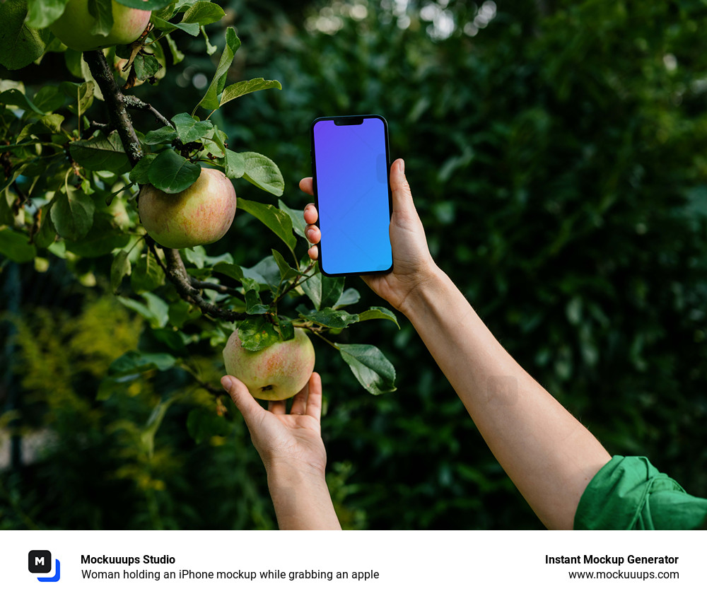 Woman holding an iPhone mockup while grabbing an apple