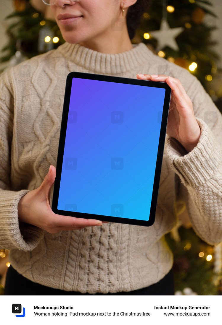 Woman holding iPad mockup next to the Christmas tree