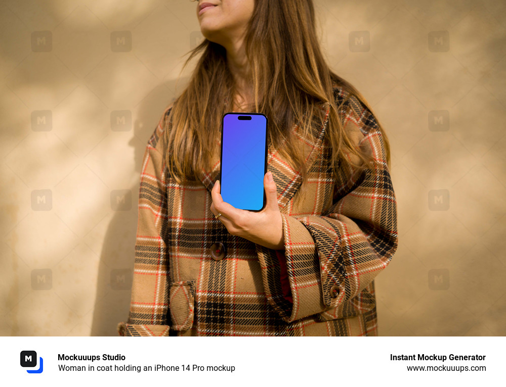 Woman in coat holding an iPhone 14 Pro mockup