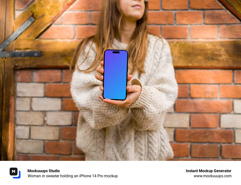 Woman in sweater holding an iPhone 14 Pro mockup
