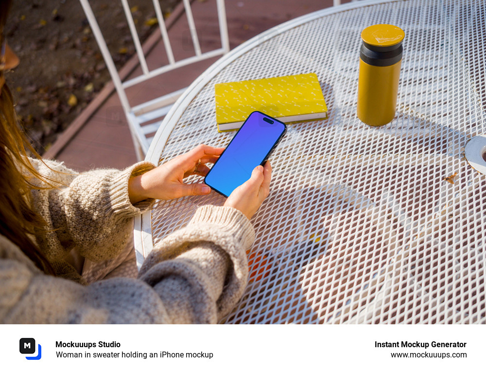 Woman in sweater holding an iPhone mockup