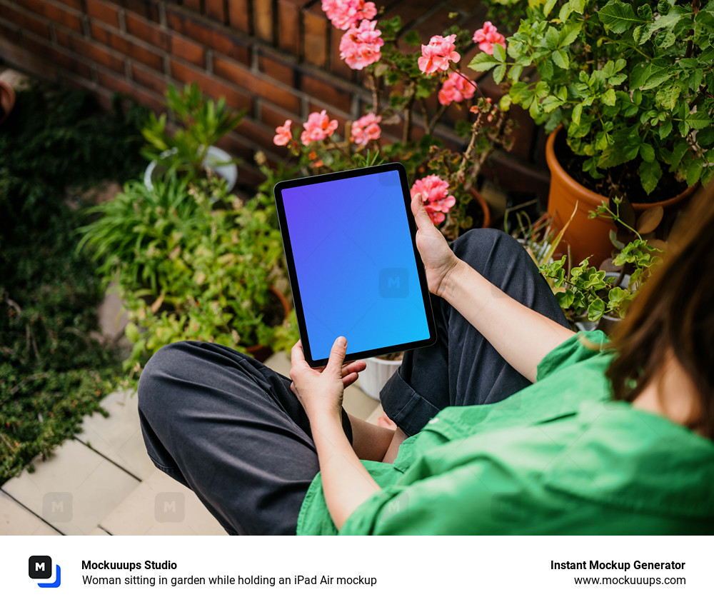 Woman sitting in garden while holding an iPad Air mockup