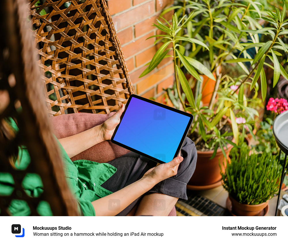 Woman sitting on a hammock while holding an iPad Air mockup