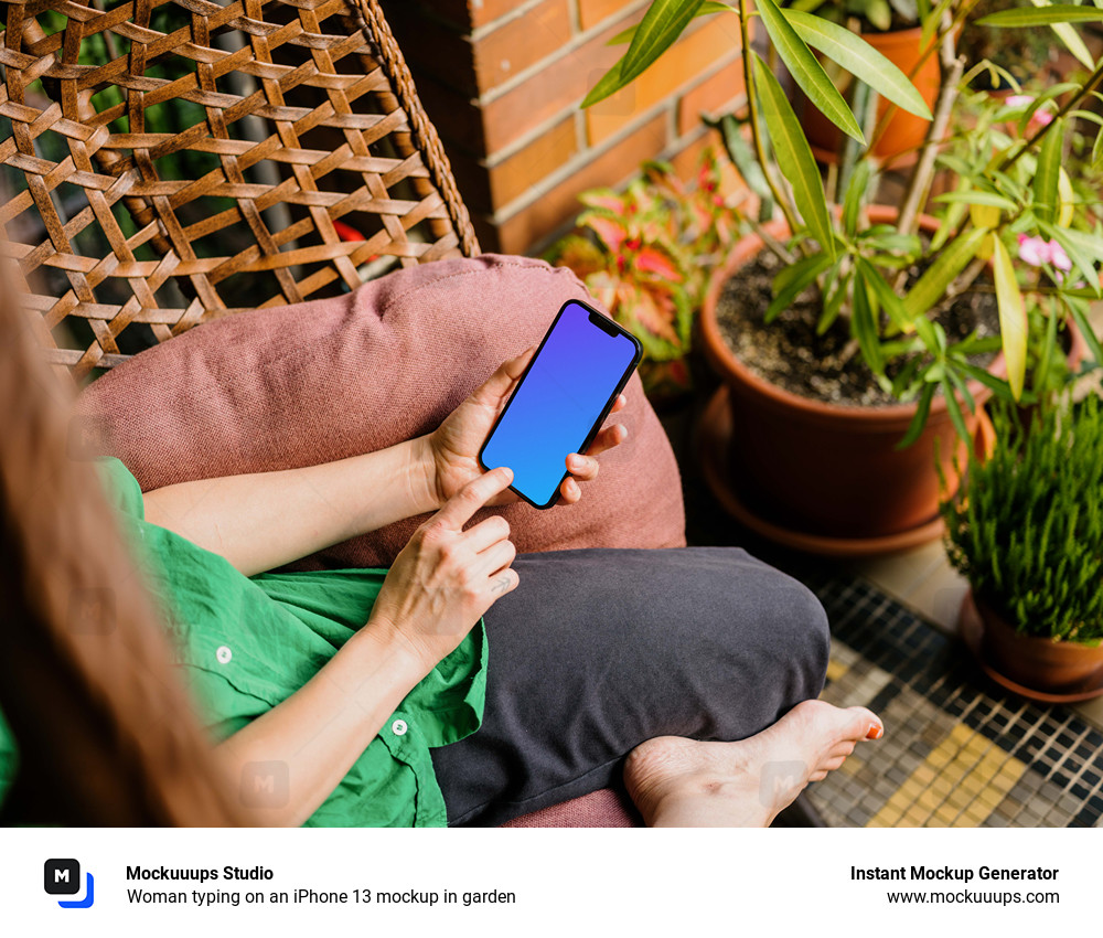 Woman typing on an iPhone 13 mockup in garden