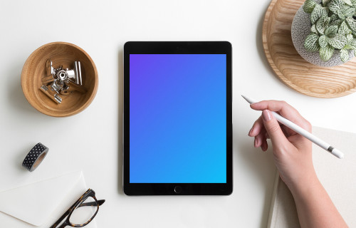 Woman holding Apple pencil over iPad Pro mockup
