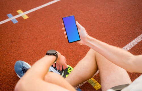Athlete holding a phone mockup