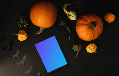 Halloween pumpkin mockup with a tablet on the dark background