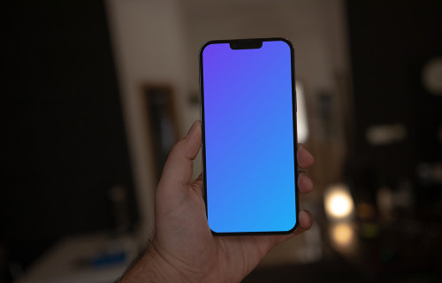 Hand holding iPhone 13 Pro mockup