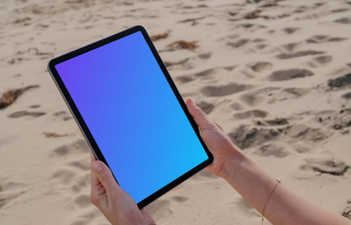 iPad Air mockup held by a user at the beach