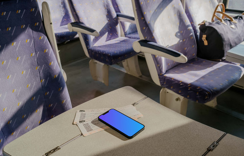 iPhone 13 mockup on table in train 