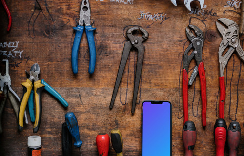 iPhone 13 Pro mockup placed next to a couple of tools