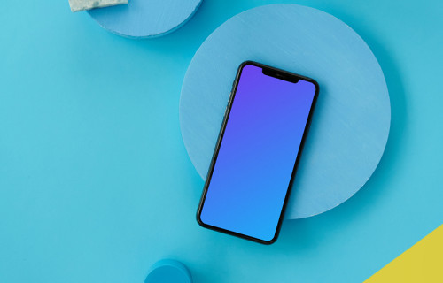 iPhone mockup on a light blue table 
