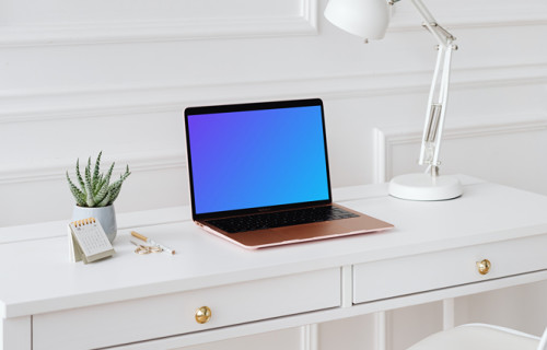 MacBook Air mockup on a desk beside a potted plant