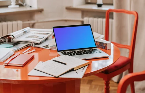 MacBook Pro mockup on a red table