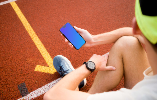 Male runner holding an iPhone 14 Pro mockup