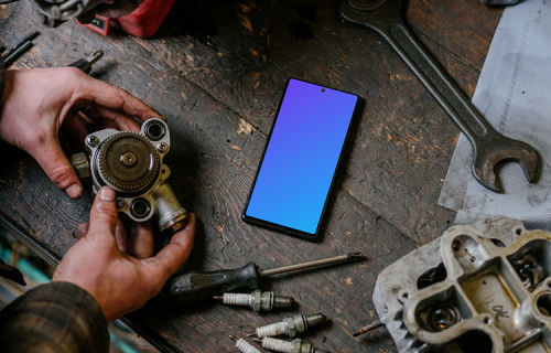 Pixel 6 mockup in front of a man seating at a workbench