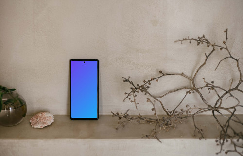 Pixel 6 mockup next to a teapot and plant